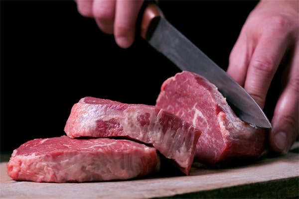 Image of a butcher cutting a tender steak from Paschall Farms